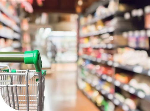 Grocery store shopping cart in aisle